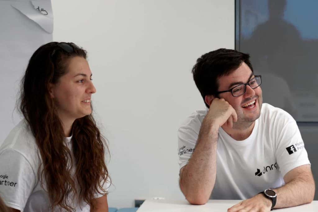 People smiling in a Team Meeting